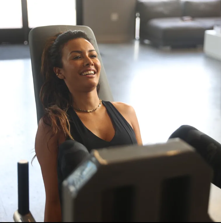 Member training on an ARX machine in a bright boutique studio